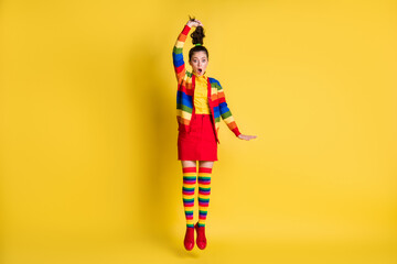 Full length body size view of childish amazed crazy cheery wavy-haired girl jumping making tail having fun isolated bright yellow color background