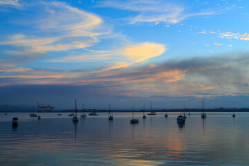 Fototapeta na wymiar Yachts on a quiet harbor at sunset