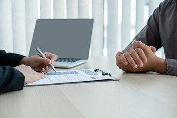 Business people hold a resume and talk to job applicants for job interviews about careers and Her...