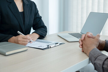 Business people hold a resume and talk to job applicants for job interviews about careers and Her personal history in the company. Recruitment concepts