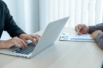 Business people hold a resume and talk to job applicants for job interviews about careers and Her...