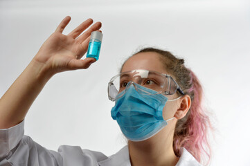 
chemical girl looks at a can of blue product