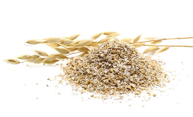 Oat bran pile and ears on stalk, groats isolated on white background