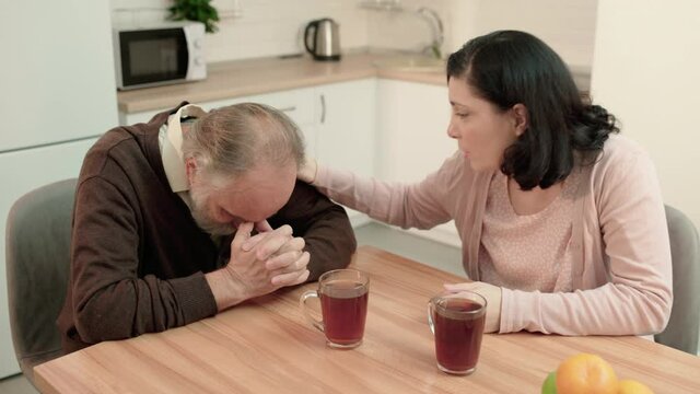 Young woman supporting sad father, comforting dad in difficult situation, care