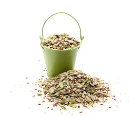 Seeds mix pile with sunflower, sesame, linseed and pumpkin seed with metal bucket isolated on white background