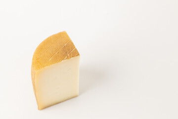 wedge of spanish cheese on white background
