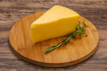 Hard cheese piece served rosemary