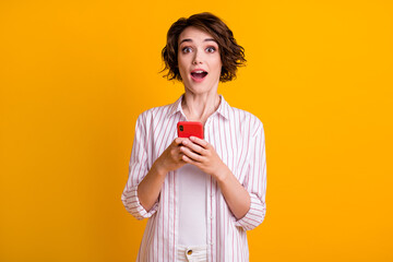 Photo of astonished girl use smartphone impressed social network communication information wear...