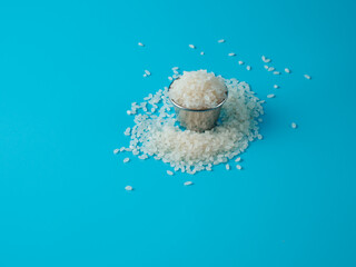 Rice cereal in the small bowl on blue background.