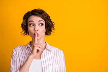 Photo of surprised girl look copyspace confidential information put index finger lips keep quiet...