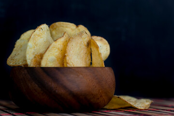 Potato chips in bamboo wooden bowl