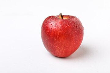 Water drop on fresh red apple on white background