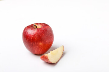 Red apple with slice on white background