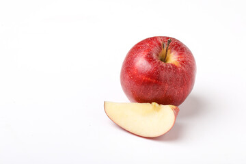 Naklejka na ściany i meble Red apple with slice on white background