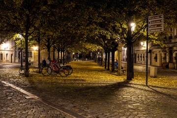 .street lights and pedestrian sidewalk with cobblestones in the center of Prague at night 2020