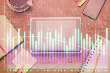 Double exposure of forex chart hologram over desktop with phone. Top view. Mobile trade platform concept.