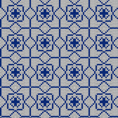Geometrical ornate seamless knitted vector pattern as a fabric texture in blue and white hues