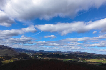 beautiful clouds on blue sky and wide view to mountains and valleys