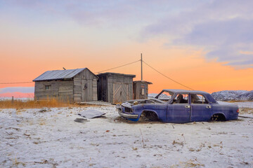 Old disassembled car at the garages in authentic village of Teriberka.