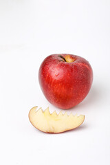 Red apple with half and slice on white background