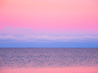 Fantastic Arctic purple evening minimalistic seascape. Natural background of magenta