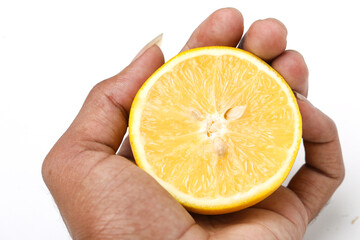 Half cut Orange or sweet lime mosambi fruit in hand on white background