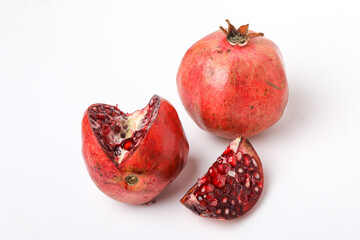 Fresh pomegranate with slice on white background