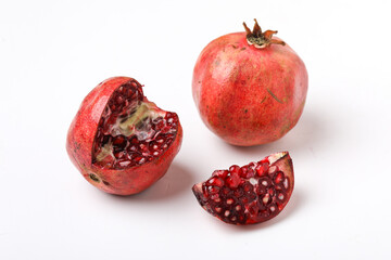 Fresh pomegranate with slice on white background