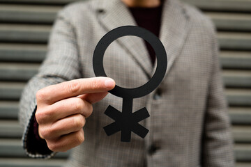 person showing a non-binary gender symbol