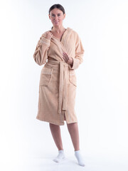 Fototapeta premium woman in a Bathrobe on an isolated white background with a smile on her face. Shot in the Studio in full growth.