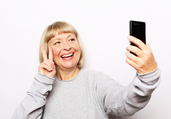 Photo of crazy ecstatic old woman use smartphone impressed social media like feedback win raise fists scream yes isolated over white background