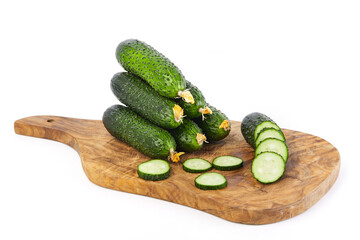 Fresh vegetables: green cucumbers whole and sliced isolated on white background macro close up. 