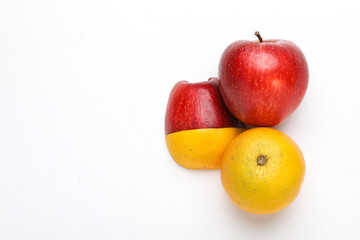 Stack of fresh fruits citrus slices, apple, orange or lemon. Colorful healthy fitness creative fun food concept. Mixed citrus fruit, apple isolated on white background