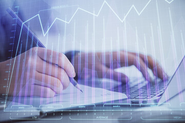 Double exposure of businesswoman hands typing on computer and forex chart hologram drawing. Financial analysis concept.