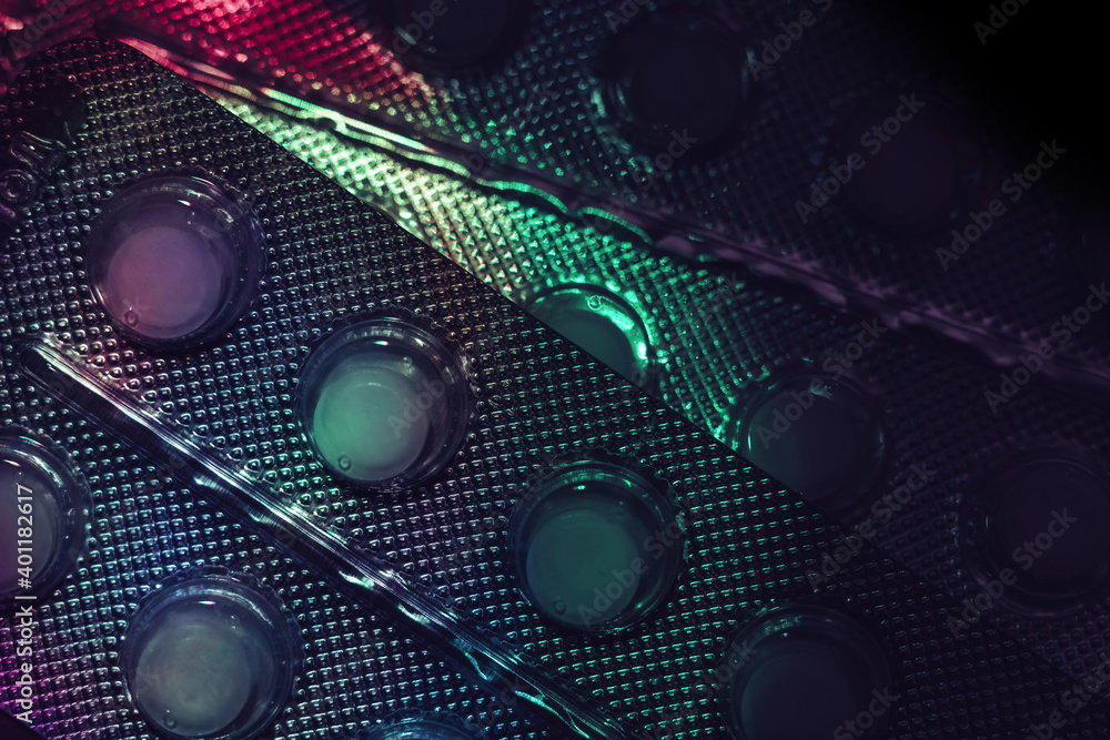 Poster pills or drugs in a package under neon light on a dark background pattern for design..