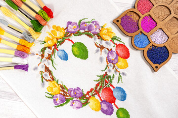 Fototapeta na wymiar Fabric embroidered Easter wreath with beads of hobby thread