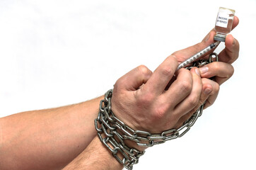 Human hands chained in chains are taking an injection into a syringe from an ampoule with a covid-19 vaccine isolated on a white background