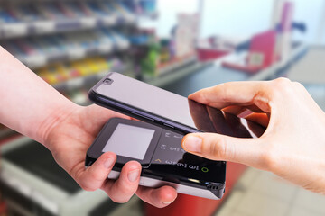 Pos terminals and smartphone. In the background is a supermarket checkout. Banking equipment. Acquiring. Acceptance of bank credit cards. Contactless payment...