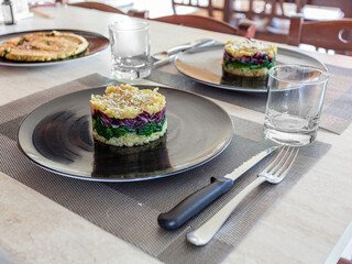 Potatoes, spinach and radicchio in a black dish. Portions for two. Vegan recipe