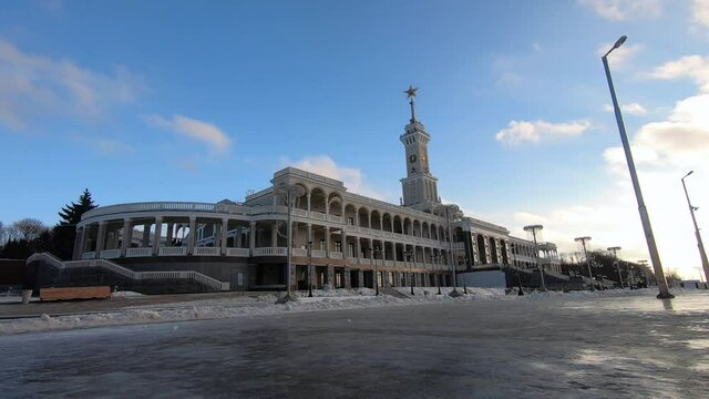 Timelapse is the historic building of the Northern River Station in Moscow after reconstruction against the background of fast-running clouds in a bright blue sky.