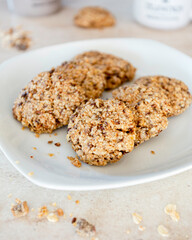 Vegan biscuits with fruit muesli, sugar, olive oil and lemon on a white plate. Vegan breakfast