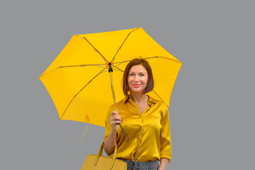 Elegant woman in a yellow ensemble in town