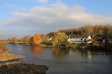 Fototapeta na wymiar Late afternoon sunshine across the beautiful Wye River at Glasbury, Powys, Wales, UK.