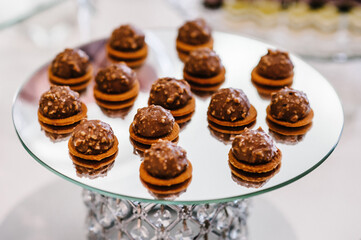 Sweet table. A plates of cakes and muffins. Table with sweets, candy, buffet. Dessert table for a party goodies. Close up. party reception, decorated in restaurant. candy bar