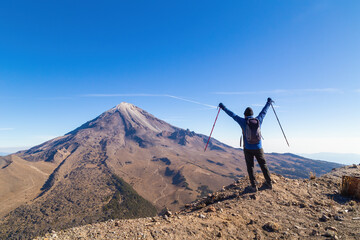 A beautiful shot of a male holding a hiking stick on both hands in Pico de Orizaba Volcano in Mexico