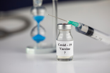 Pandemic and time Concept , Time to Vaccinate. Vaccine Bottle with Syringe for Covid-19 and...