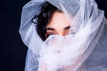 Beautiful woman  with white veil  on black background