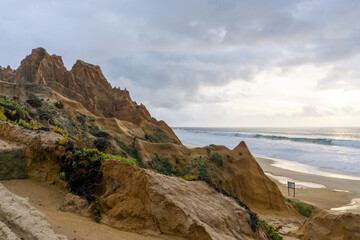 large sand dunes and broken up beach access road severely affected by wind and water erosion on the coast