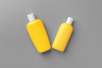 Yellow cosmetic container on gray background top view