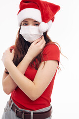 Fototapeta na wymiar girl wearing a medical mask new year clothes christmas holiday light background